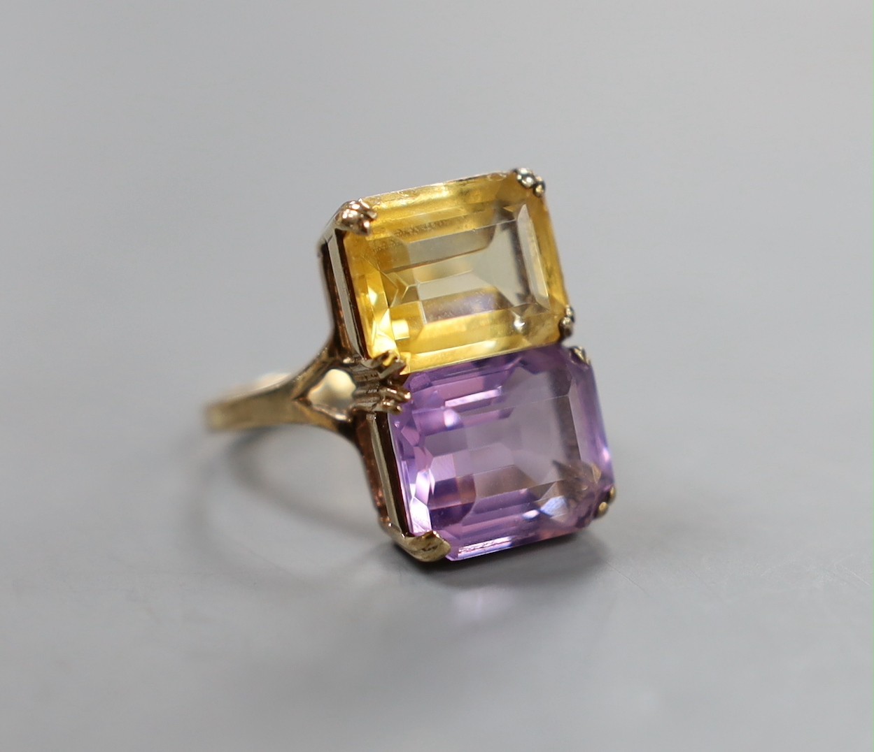 A mid 20th century 9ct gold, amethyst and citrine set two stone dress ring, size N, gross weight 5.2 grams.